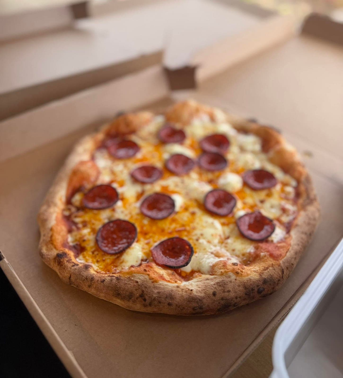 Pepperoni sourdough pizza in a takeaway box