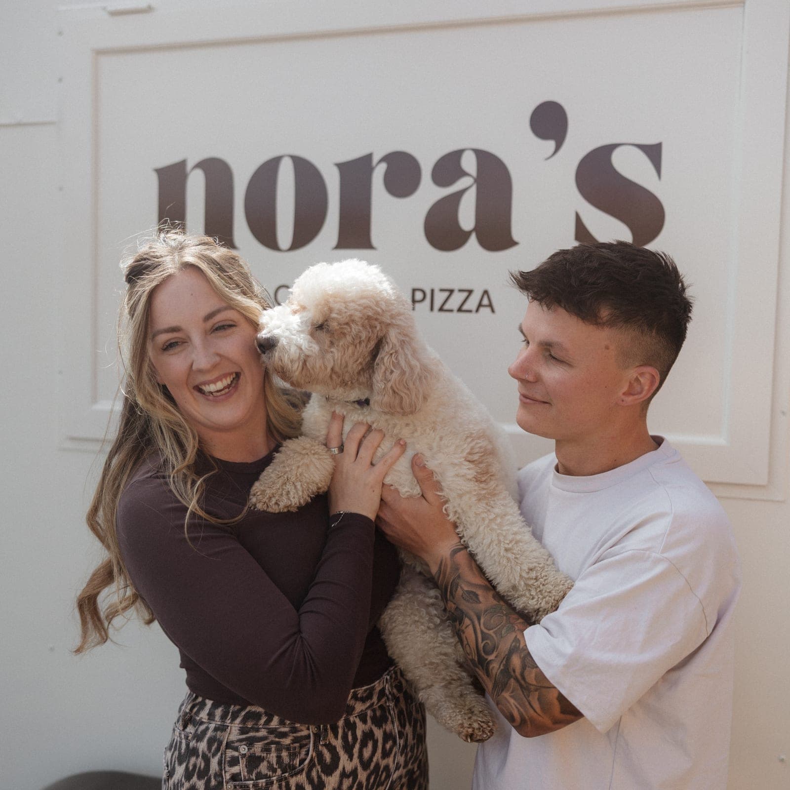 The Nora’s team with their dog in front of the trailer